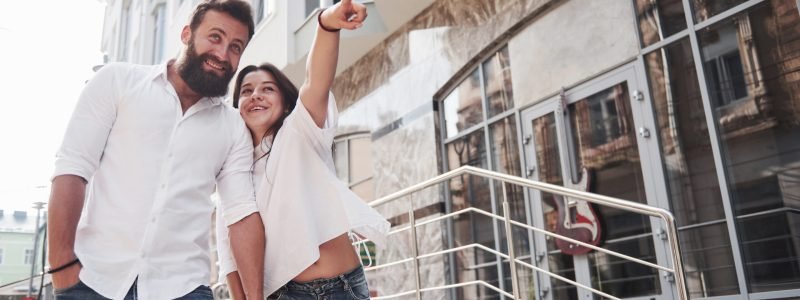 A young funny loving couple have fun on a sunny day